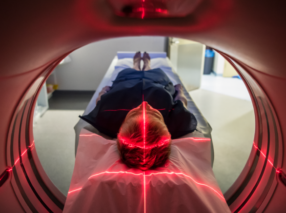 A patient laying down getting a CT scan