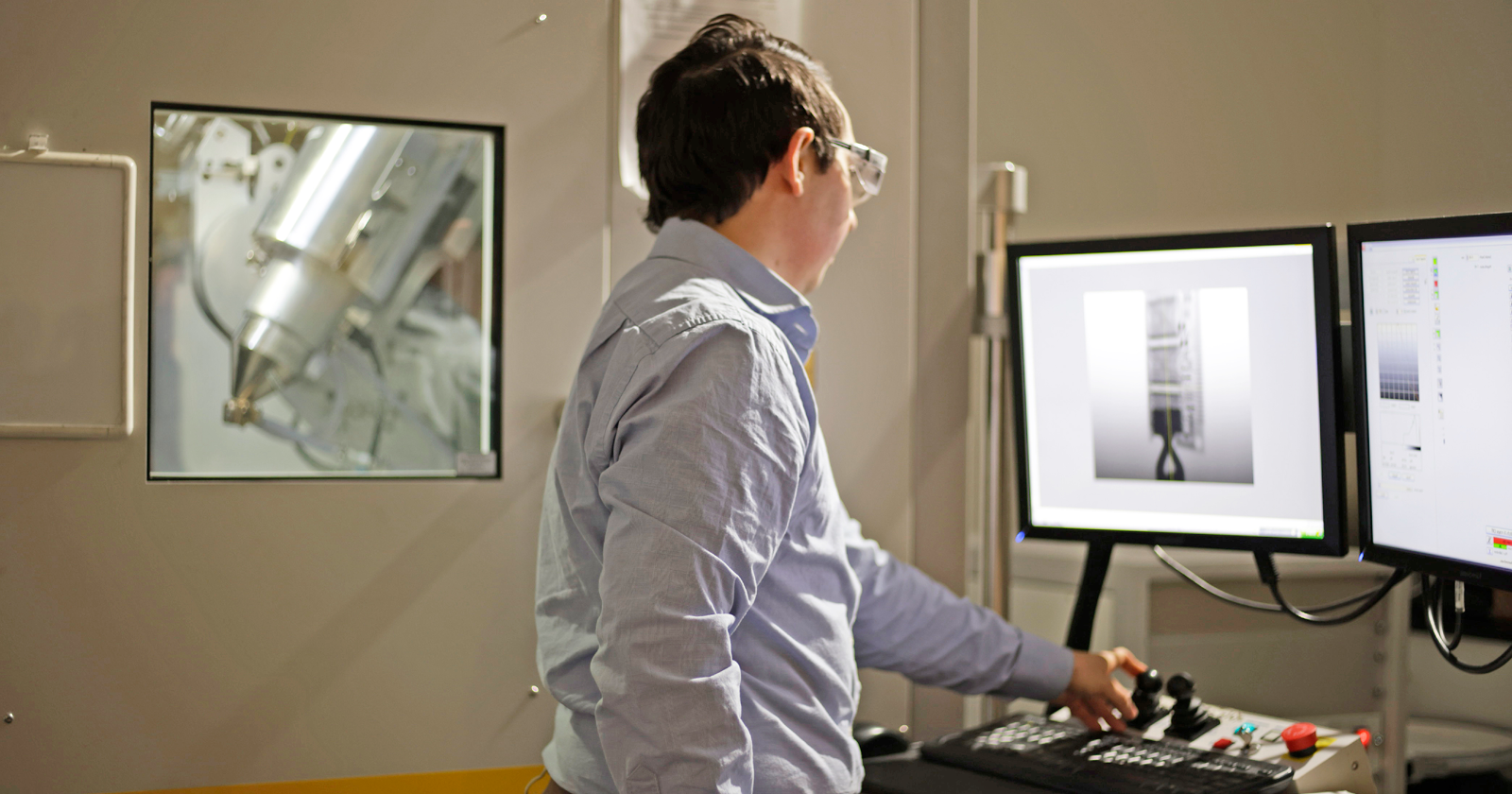 A scientist analyzes images of batteries on two computer screens. Exponent engineers help improve the safety and performance of batteries. 