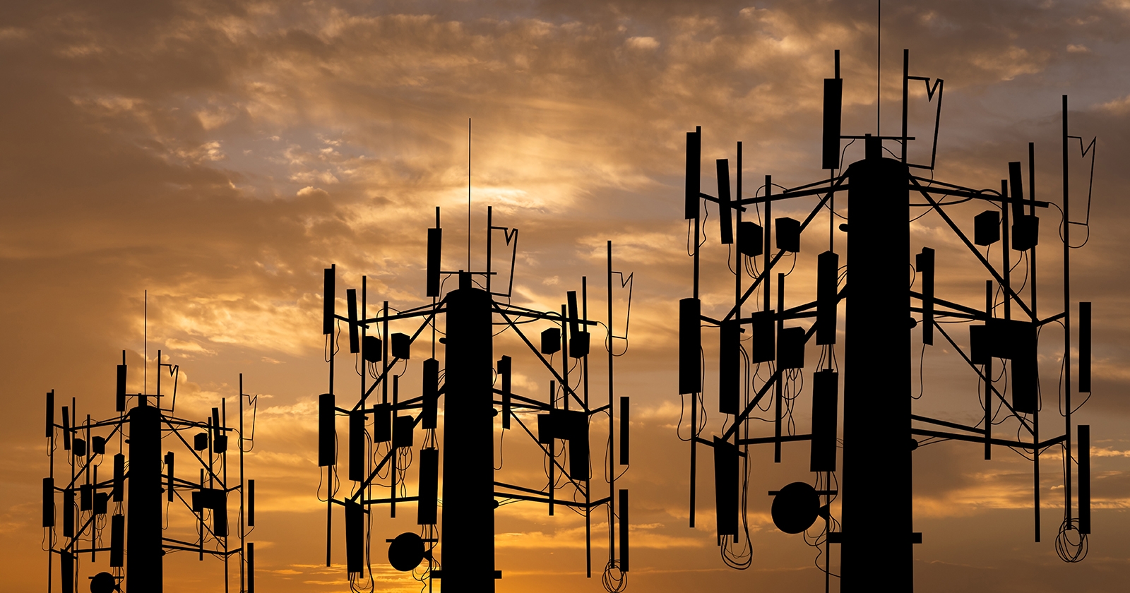 Three tall communication towers. Exponent engineers provide technical expertise for all wireless communications.