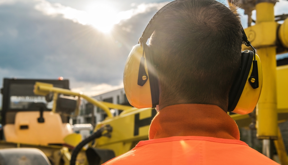 Construction worker wearing noise reduction headsphones
