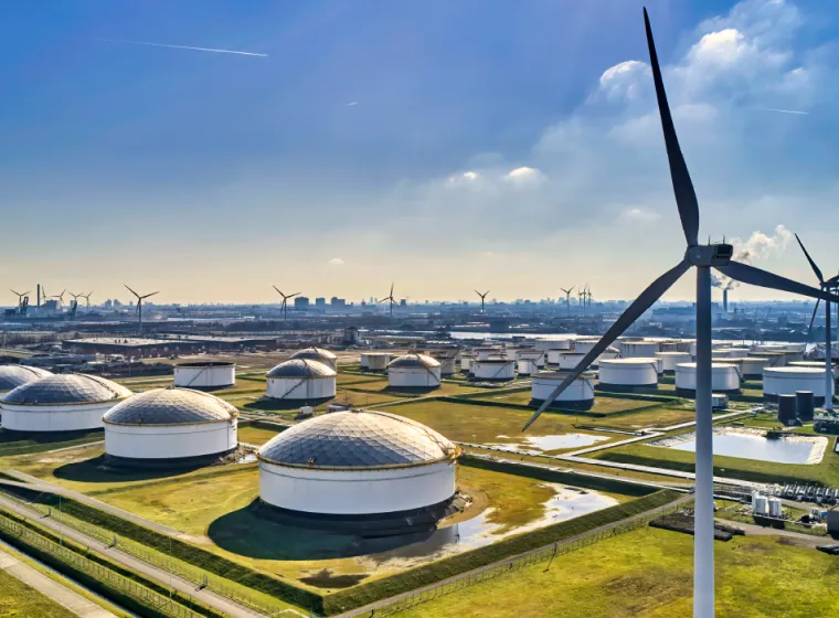 Aerial view of an energy facility with multiple windmills and domes