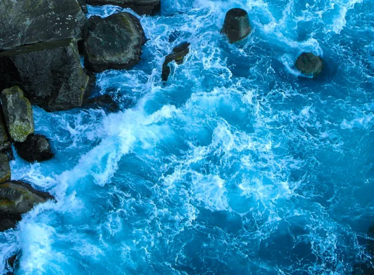 Blue waves of the ocean near the rocks. 