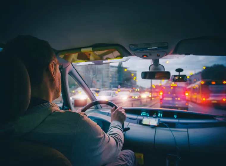 Driving a car in the city at night in traffic jams