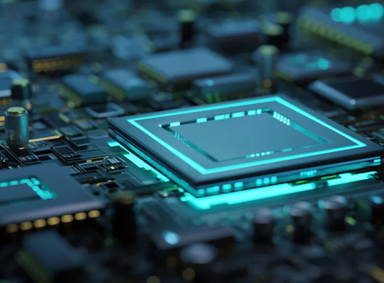A green glow radiates from a computer circuit board. Exponent engineers analyze the thermal and electrical performance support. 