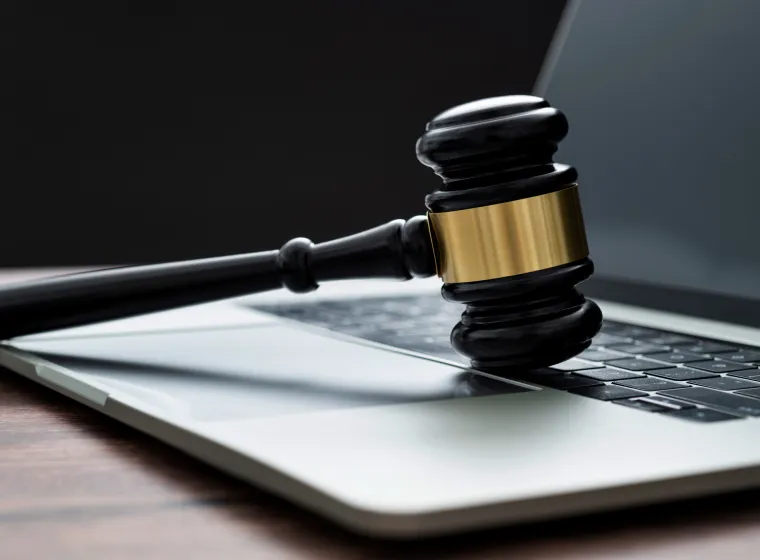 Gavel and laptop on the table