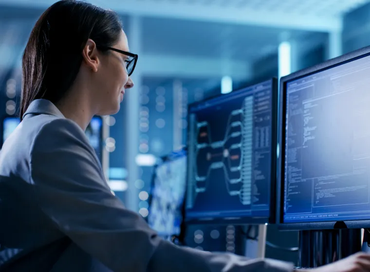  Close-up Shot of Female IT Engineer Working in Monitoring Room. She Works with Multiple Displays.