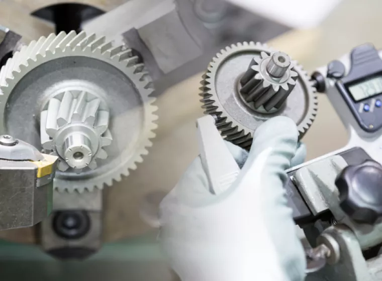 Calibrating gears. Exponent engineering supports testing, research, and development for industrial equipment manufacturing.