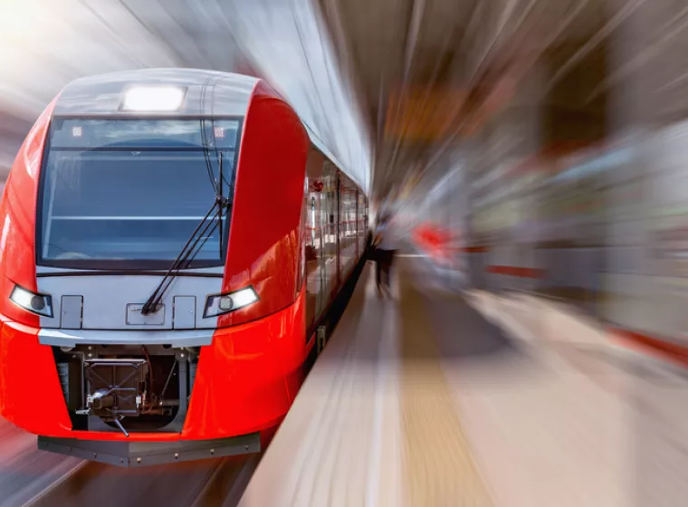 High speed passenger train in station. Exponent helps improve the safety and performance of rail transportation.