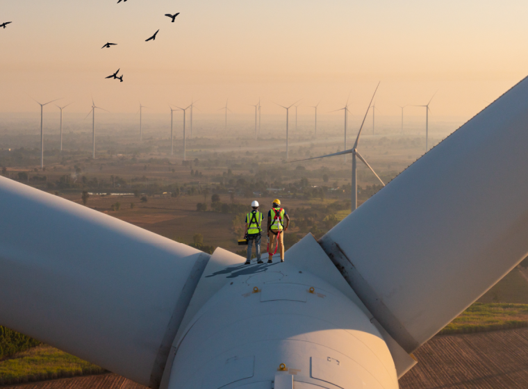 Sustainability & Climate Change Wind Turbine Engineers Standing on the Turbine