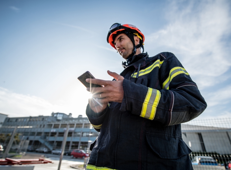 Firefighter looking at his device