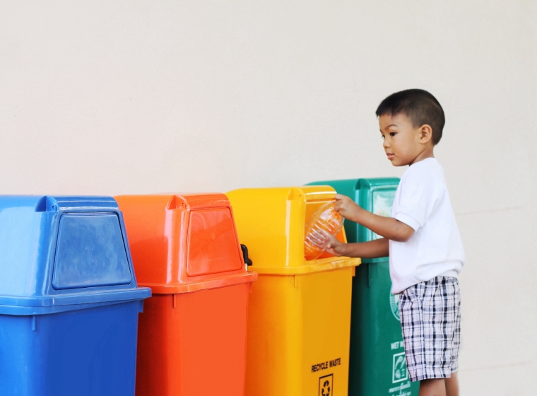 Boy recycling plastic
