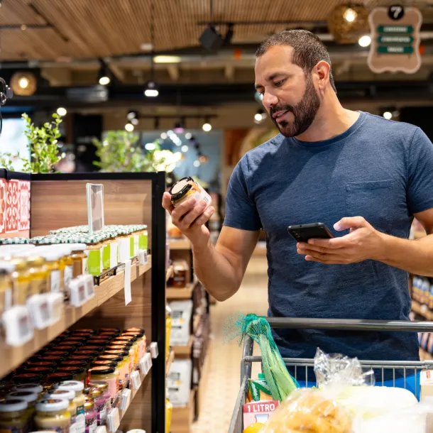 Healthy eating man shopping for organic products at the supermarket