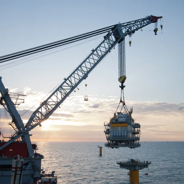 crane vessel installing a transformer platform in a windfarm