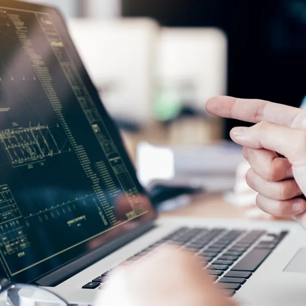 Consultants analyze data on laptop screen. Exponent engineers perform quantitative risk assessment for buildings and structures.