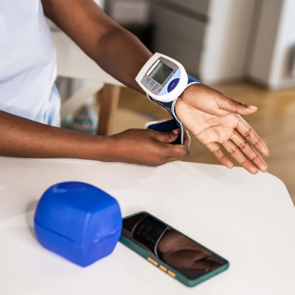 Young woman measuring a blood pressure at home