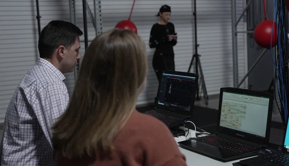 Experts evaluate test subject in UX lab. Exponents' user research and testing services analyze human factors.