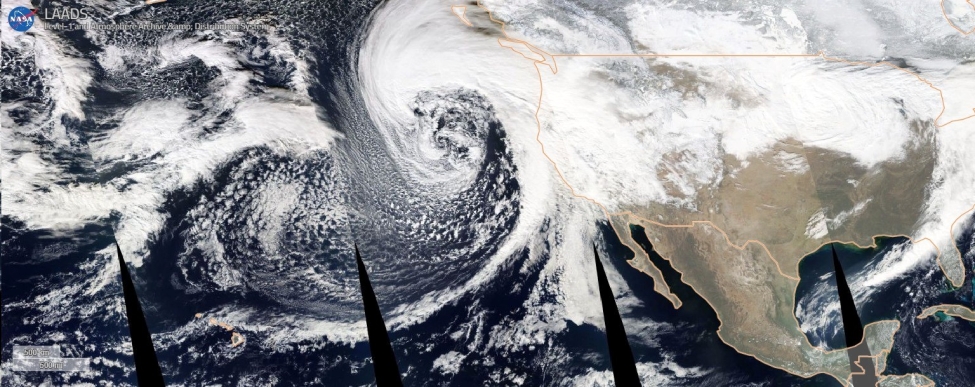 True color image mosaic from NASA’s MODIS instrument aboard the Aqua satellite, taken on Jan. 4, 2023. The “bomb cyclone” is the spiral of clouds in the upper center of the image. The thin band of clouds stretching from Hawaii to the California coast is the atmospheric river that brought high winds and rain to California Jan. 4-5.