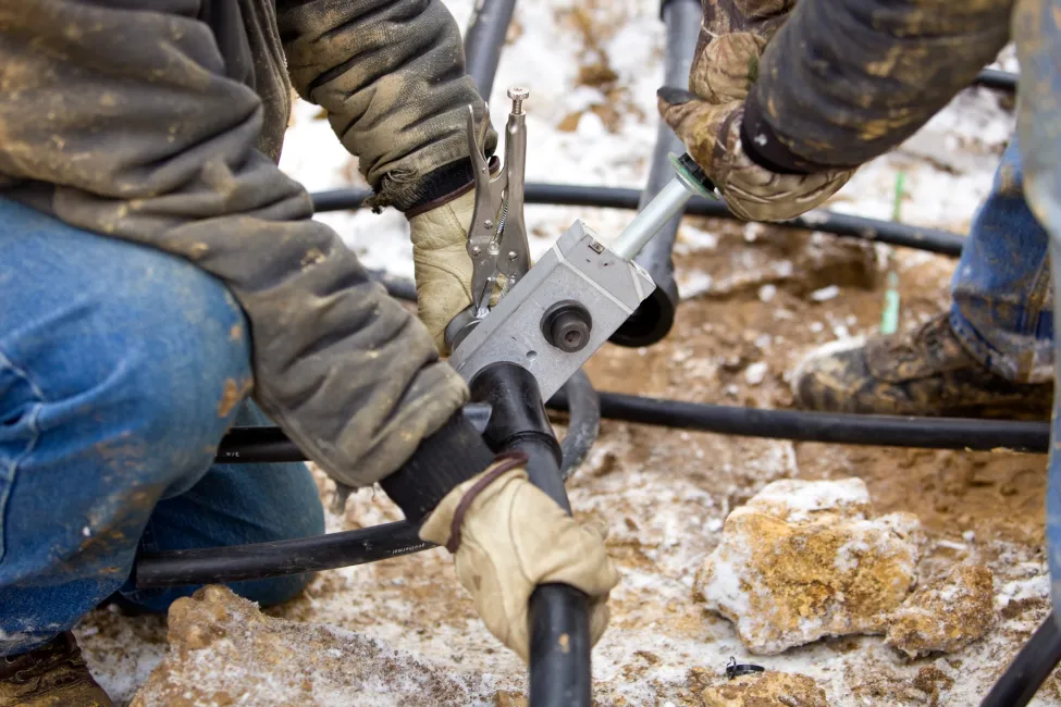 Two Workers Join Residential Geothermal Heating/Cooling Pipe