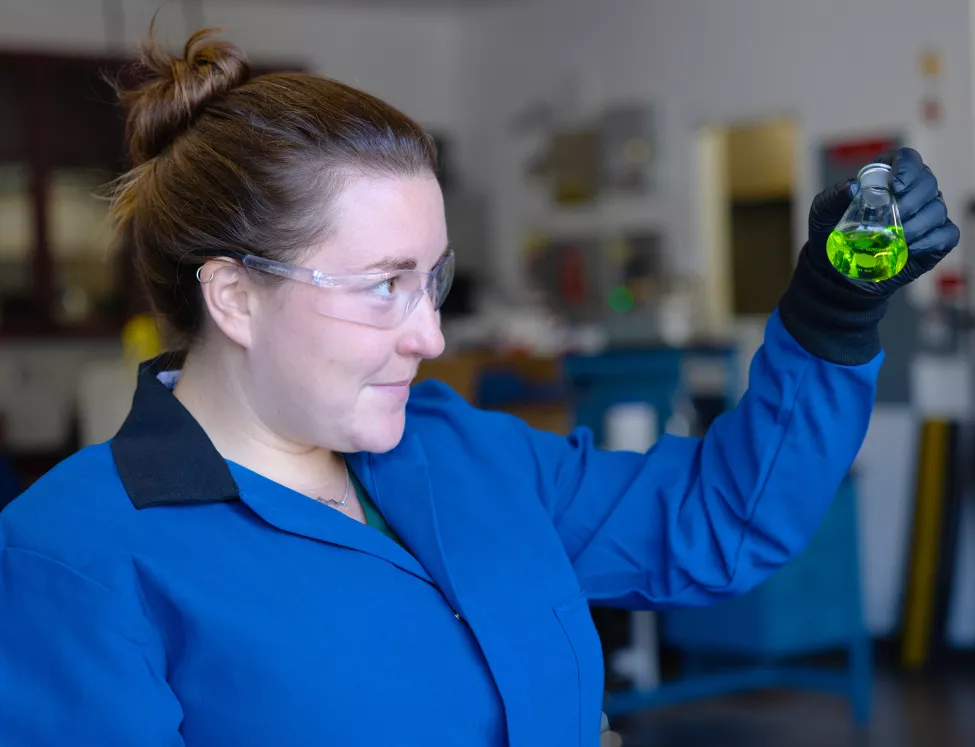 scientist looking at flask