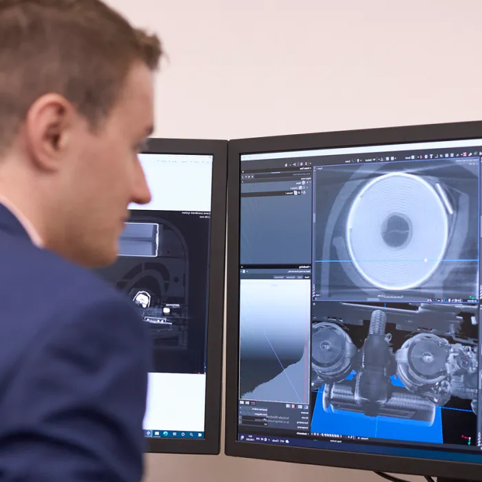A person reviews the detailed images of batteries on a computer screen. Exponent conducts detailed battery analysis for safety and performance. 