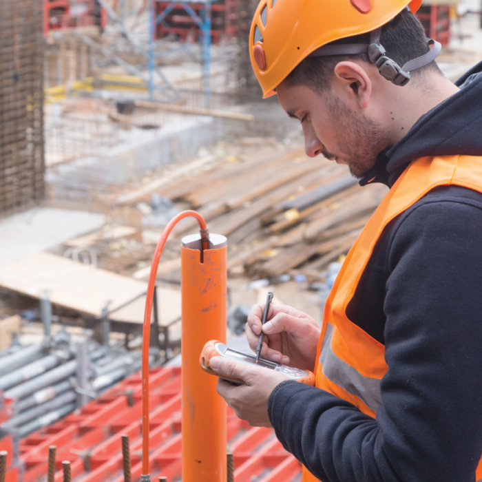 An engineer uses geotechnical instrumentation and monitoring to evaluate construction site safety.