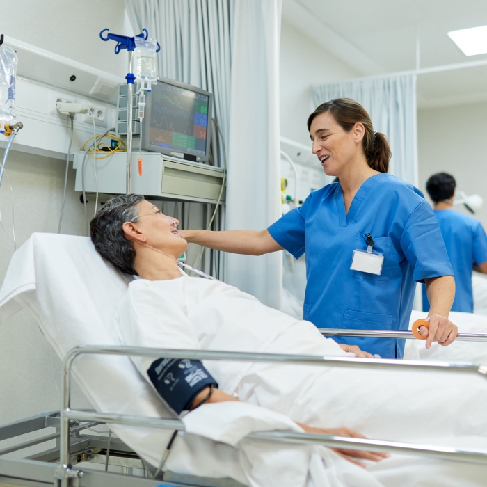 A nurse is comforting a patient before the surgical procedure. 