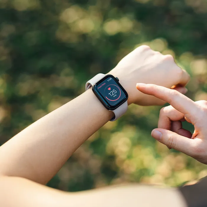 A runner checks their smartwatch. Exponent helps manufacturers develop safer and more innovative health monitoring and wearable devices.