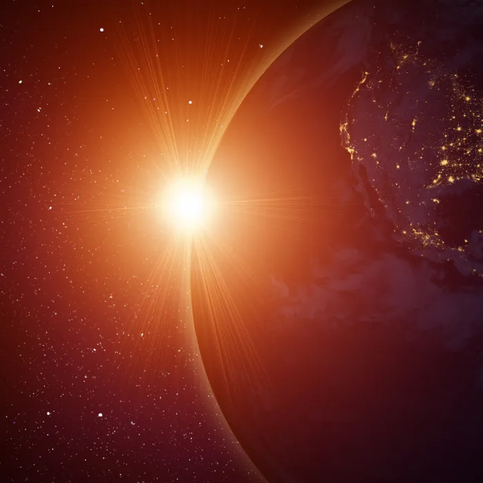 Rising sun behind planet