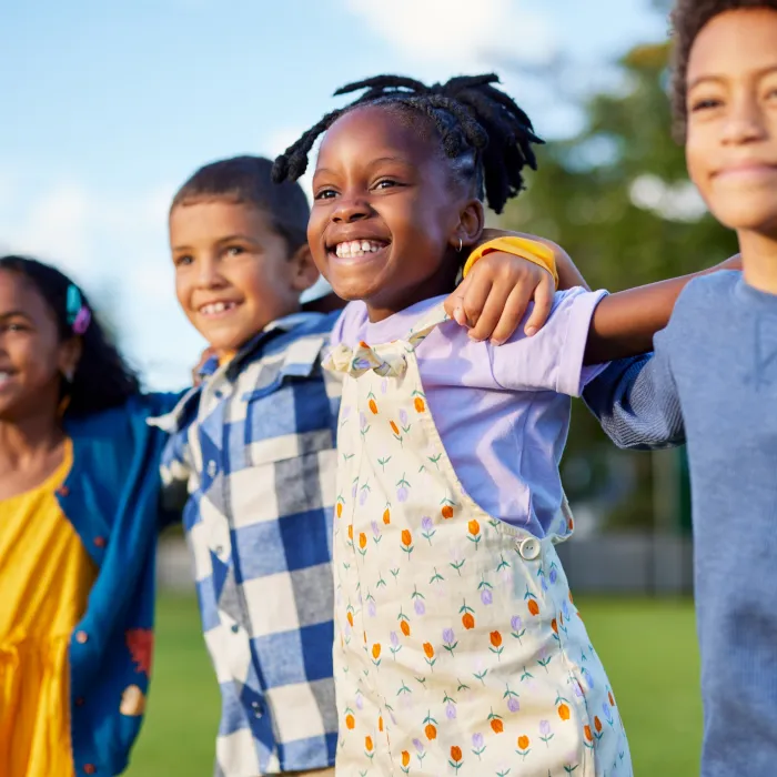 Multiethnic group of children friends enjoy together while hugging 
