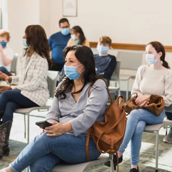 Diverse Group of People Waiting Patiently in a Doctor's Office