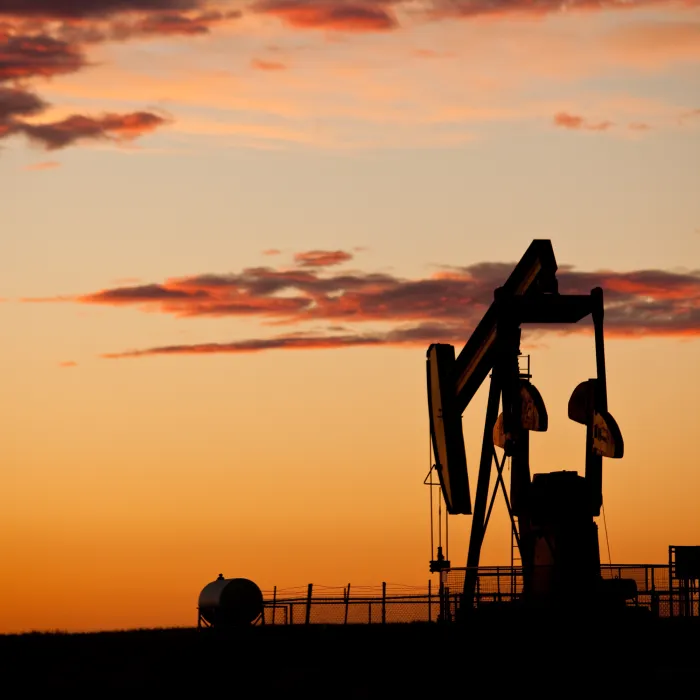 A pumpjack in Texas. The oil and gas industry is a major player in the Texas economy. This oil rig is in an oil field near Houston. Fuel and power generation as well as pollution and the environment are other themes for this vibrant image. Crude oil, oil rig, industrial equipment, environment, clean energy, fossil fuel, sunrise, landscape, and scenic image. Nobody is in this photograph, taken with Canon Mark II camera and L series lens.