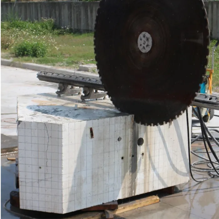 A cutting machine blade slicing through a massive block of concrete.