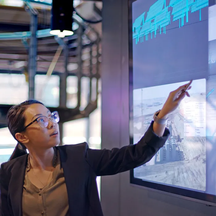 Woman making hi-tech presentation on screens