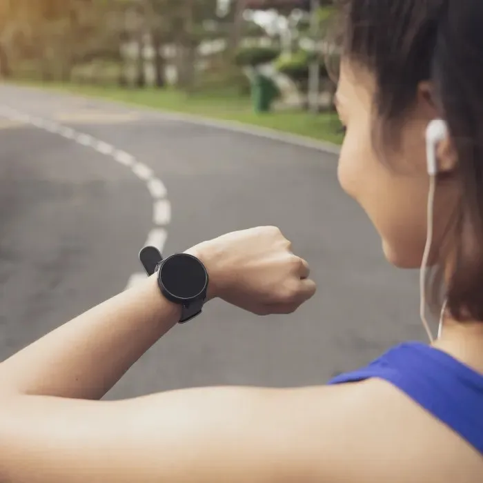 Jogger looking at digital watch.