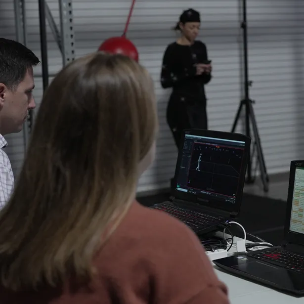 Experts evaluate test subject in UX lab. Exponents' user research and testing services analyze human factors.