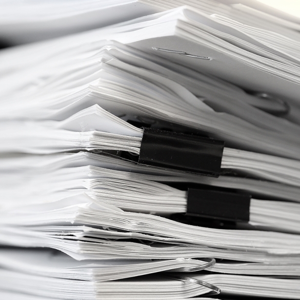 A stack of legal papers on a desk. Exponent provides technical expertise for all types of legal claims and disputes. 