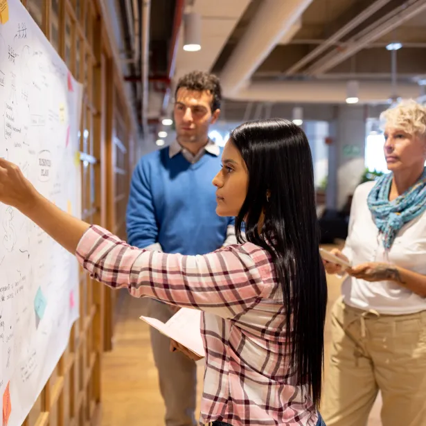 Latin American business team brainstorming at the office while creating a business strategy