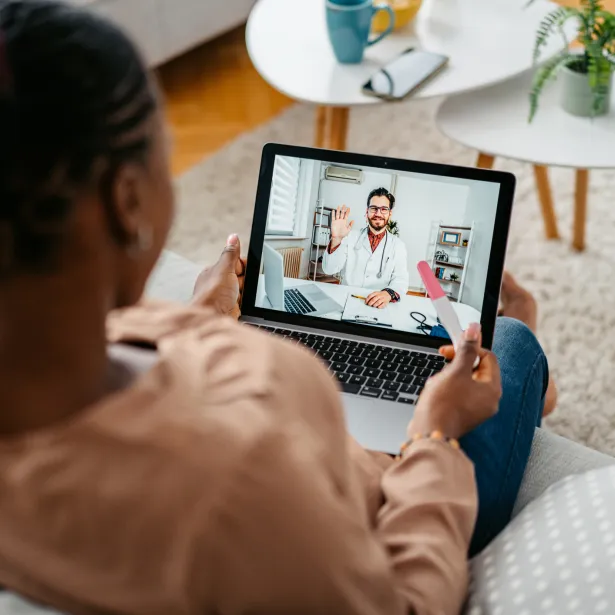 Young Pregnant Woman Having A Doctor's Appointment On A Laptop