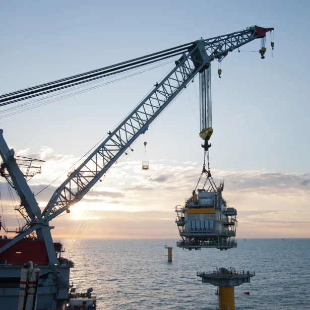crane vessel installing a transformer platform in a windfarm