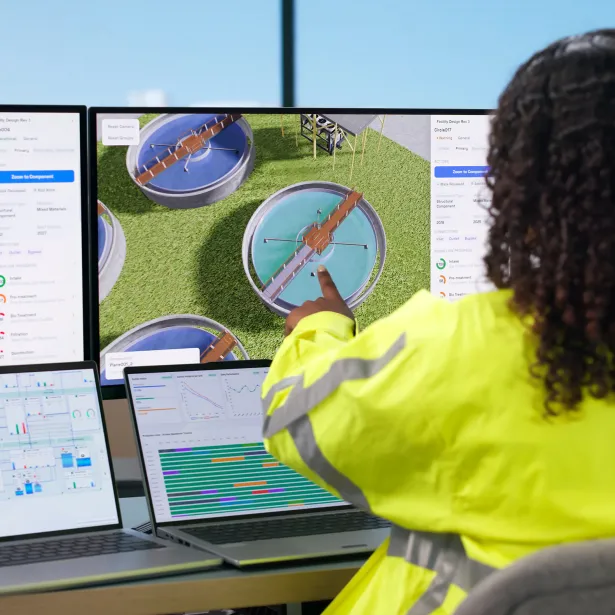Woman Engineer Uses Computer To Monitor Water Treatment System Quality.