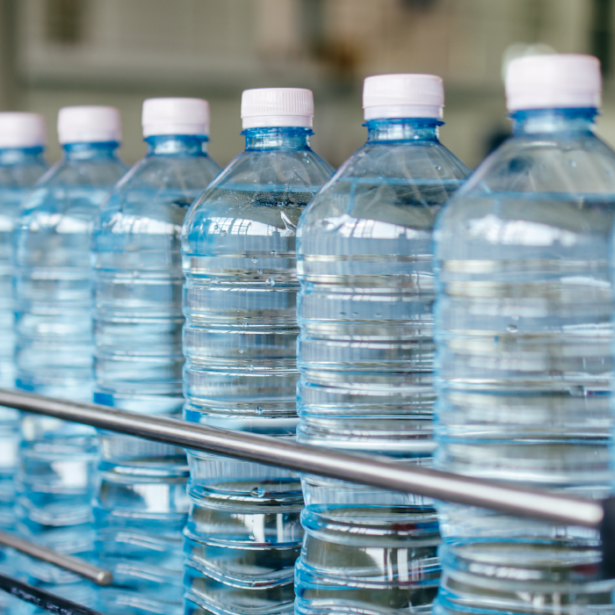 Plastic water bottles moving through a production line.