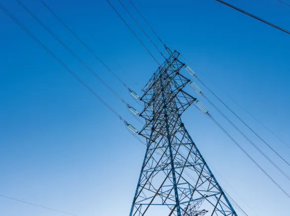 A view of electric lines from the point of view at the base of the tower