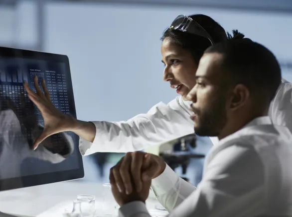 Scientists Working on Computer In Modern LaboratoryNOTE TO INSPECTOR: all graps, dna models, charts are made by me