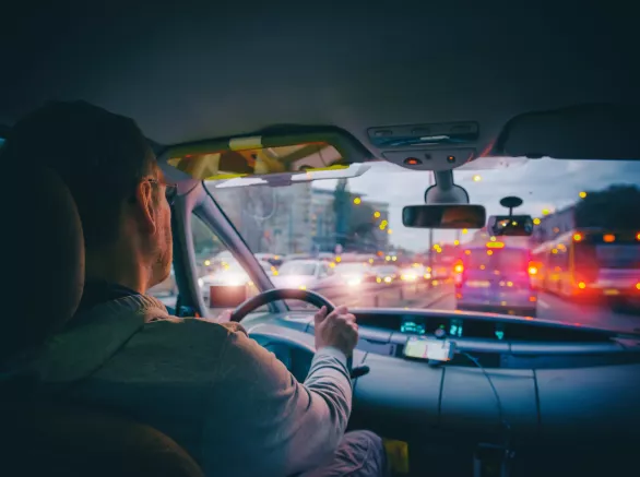 Driving a car in the city at night in traffic jams