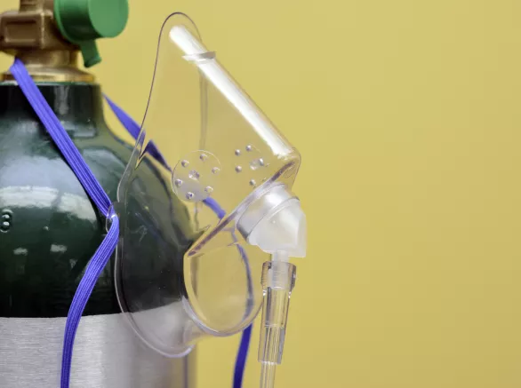 Oxygen Mask Hanging from Medical Oxygen Tank 
