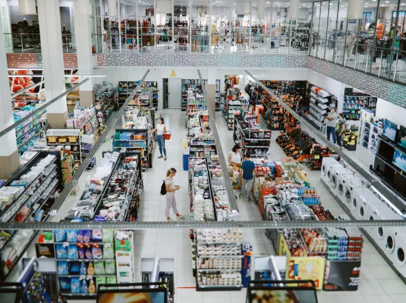 Overhead image of people buying in the large supermarket.