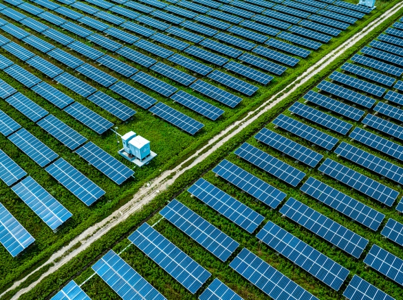 A field filled with a grid of multiple solar panels