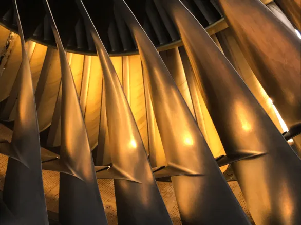 An illuminated jet engine in golden colors