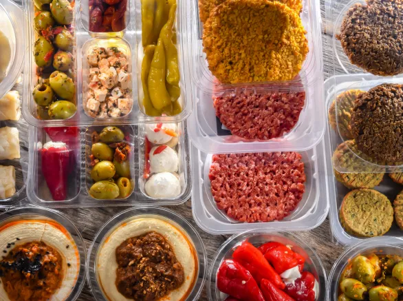 Variety of prepackaged food products in plastic boxes