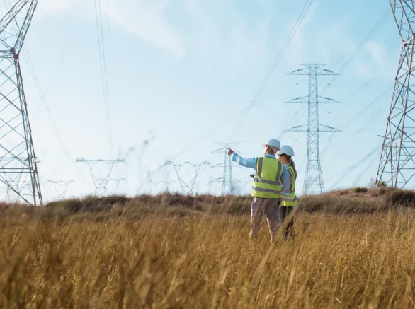 Teamwork, electrical engineer and inspection in power station with people for electricity transmission and tower check. Engineering, back and collaboration for energy distribution or mockup in field 